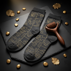 Premium reflexology socks with acupressure zone map and wooden massage tool on dark moody background